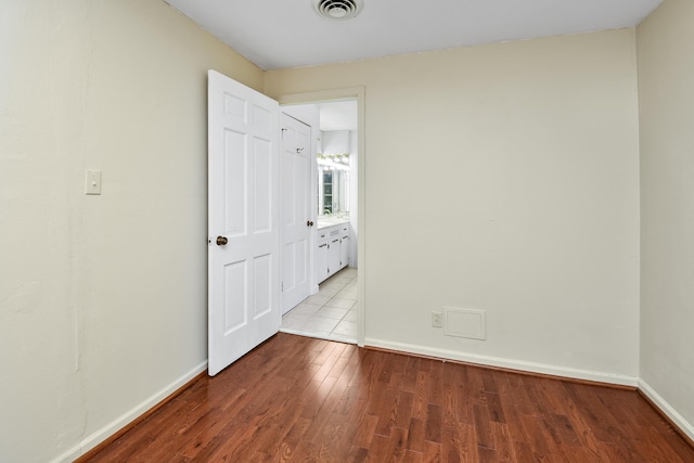 3011 E Lamonta Dr, Springfield, MO 65804 - unfurnished bedroom with wood finished floors and baseboards