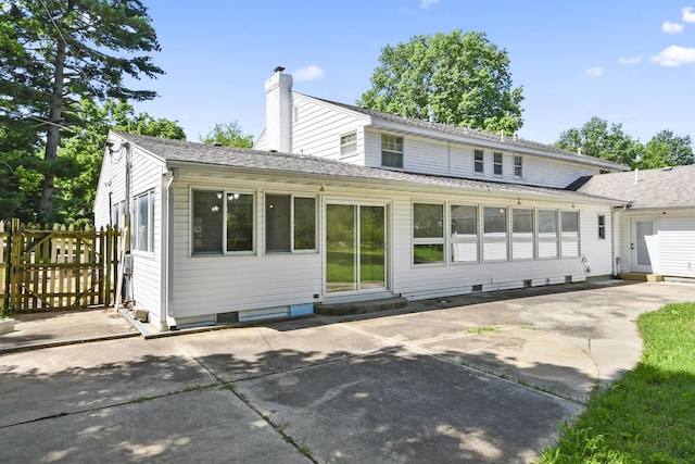 3011 E Lamonta Dr, Springfield, MO 65804 - rear view of house with entry steps, a patio, a chimney, and roof with shingles