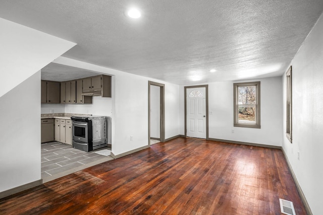 unfurnished living room with a textured ceiling and light wood-type flooring