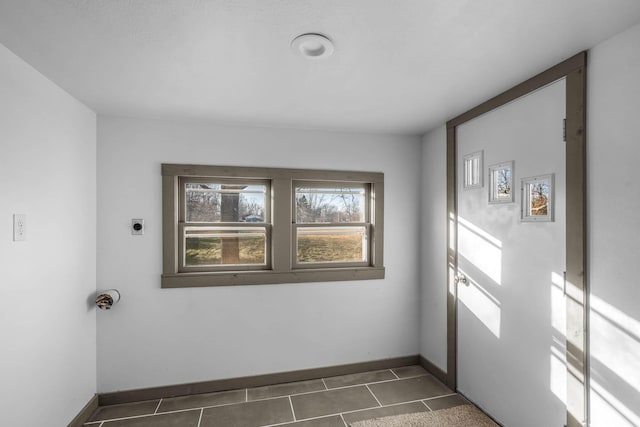 doorway with dark tile patterned floors