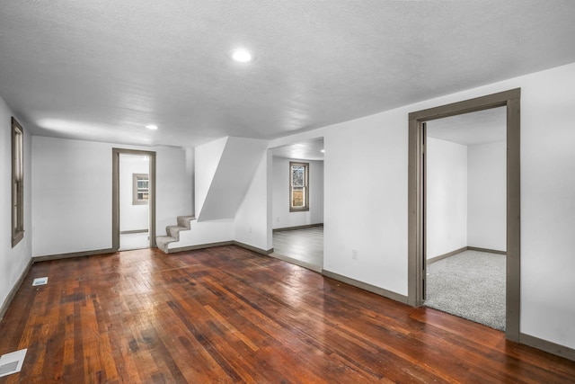 interior space featuring dark hardwood / wood-style flooring and a textured ceiling