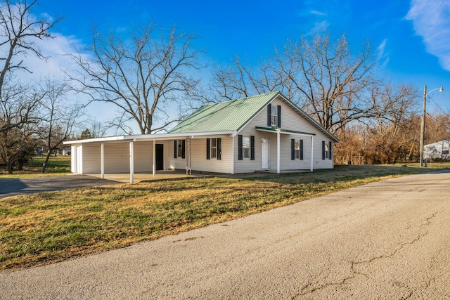 single story home with a front lawn and a carport