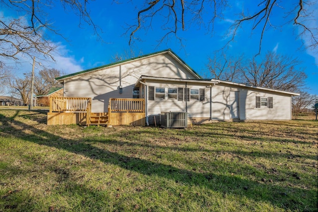 back of property with a yard, central AC, and a wooden deck