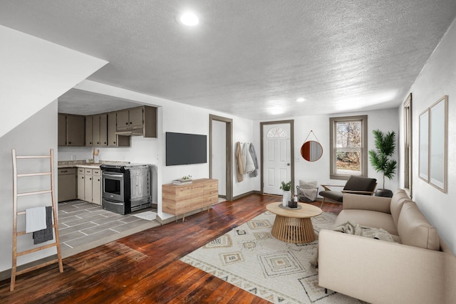 living room featuring a textured ceiling and light hardwood / wood-style flooring