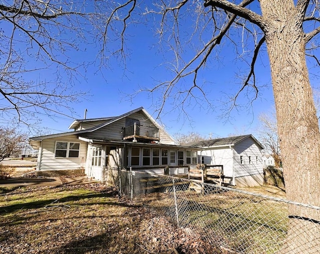 rear view of house featuring a sunroom