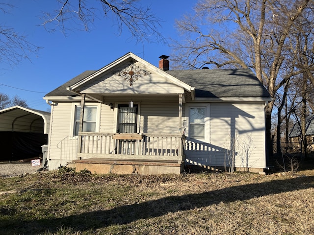 view of front of home with covered porch and a carport