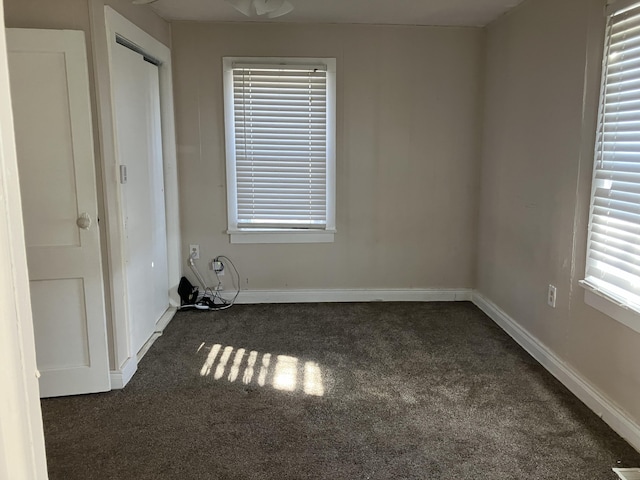 empty room with dark colored carpet