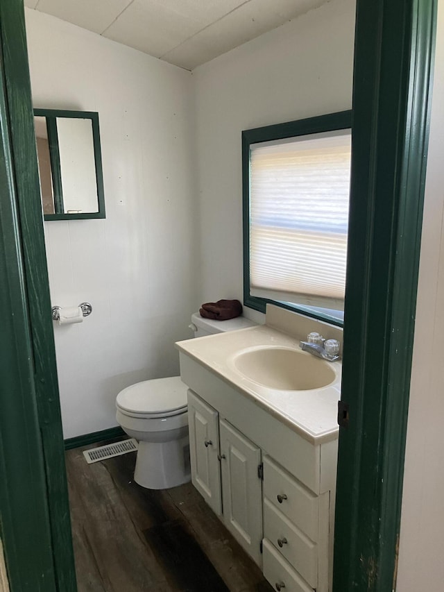 bathroom featuring hardwood / wood-style floors, vanity, and toilet