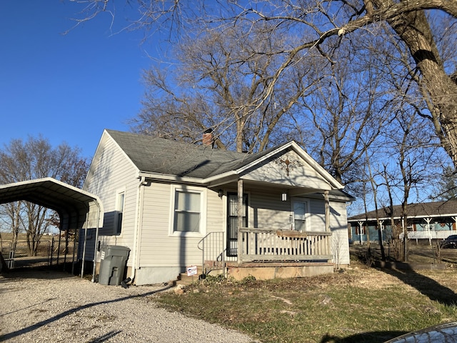 bungalow-style house with a carport and covered porch