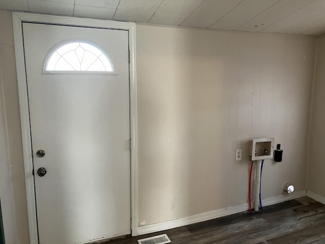 foyer with wood walls and dark wood-type flooring