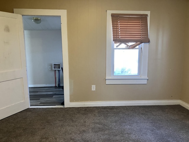 unfurnished bedroom with dark carpet