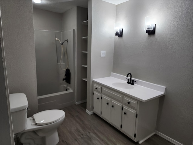 full bathroom with hardwood / wood-style flooring, vanity, shower / bathtub combination, and toilet