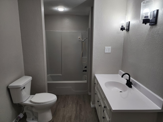 full bathroom featuring hardwood / wood-style flooring, vanity, toilet, and shower / bathing tub combination