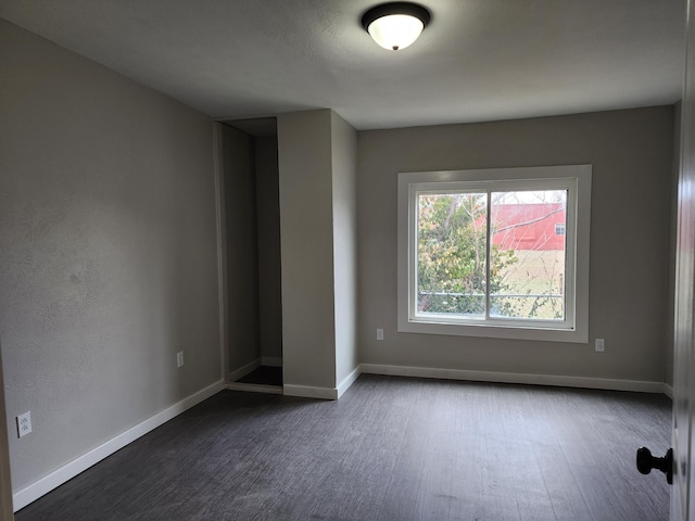 spare room with dark hardwood / wood-style floors