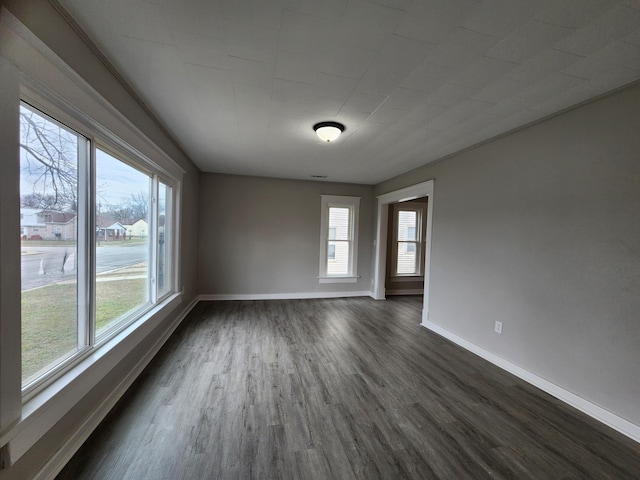 spare room featuring dark hardwood / wood-style flooring