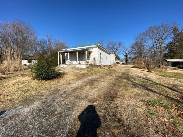 view of side of property with a porch