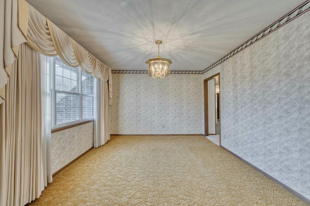 unfurnished room featuring carpet, a textured ceiling, and a chandelier