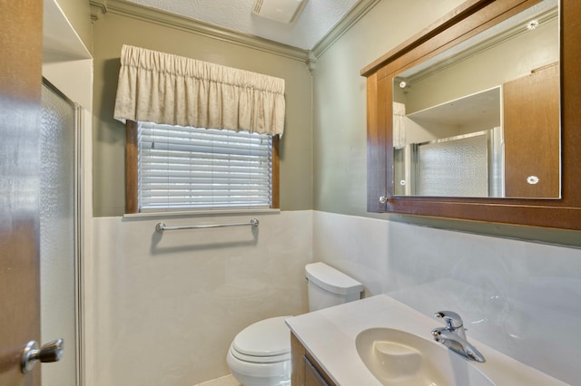 bathroom with crown molding, vanity, a shower with shower door, and a textured ceiling