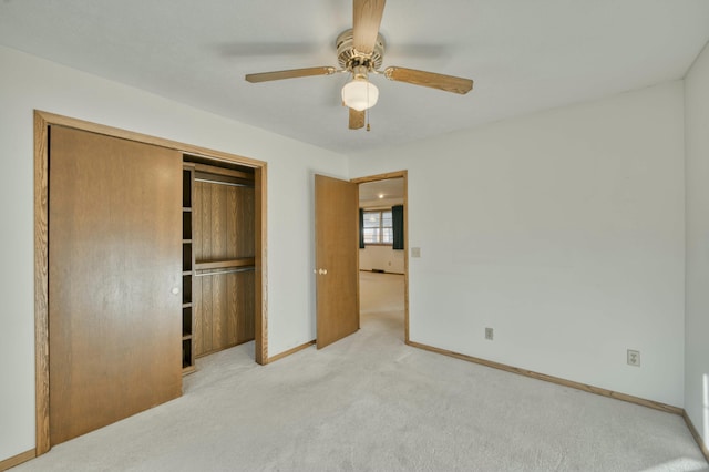 unfurnished bedroom with a closet, ceiling fan, and light colored carpet