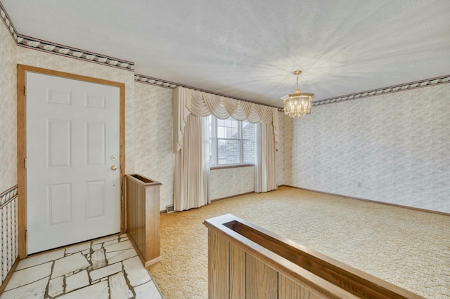 foyer with a textured ceiling and an inviting chandelier