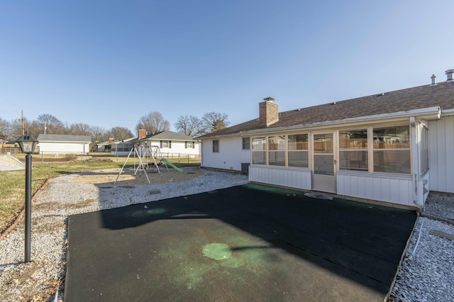 back of house featuring a playground