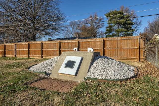 view of storm shelter featuring a lawn