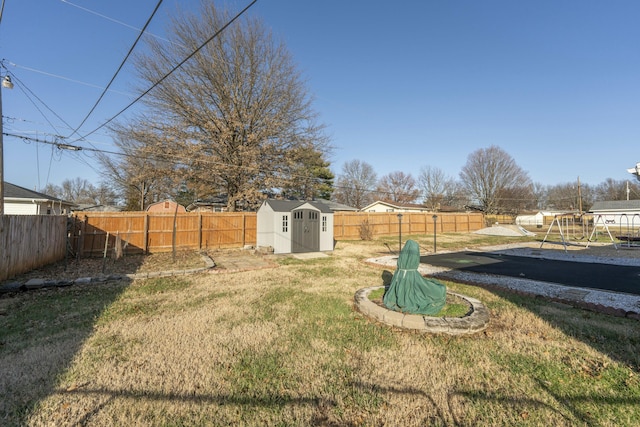 view of yard with a playground and a storage unit