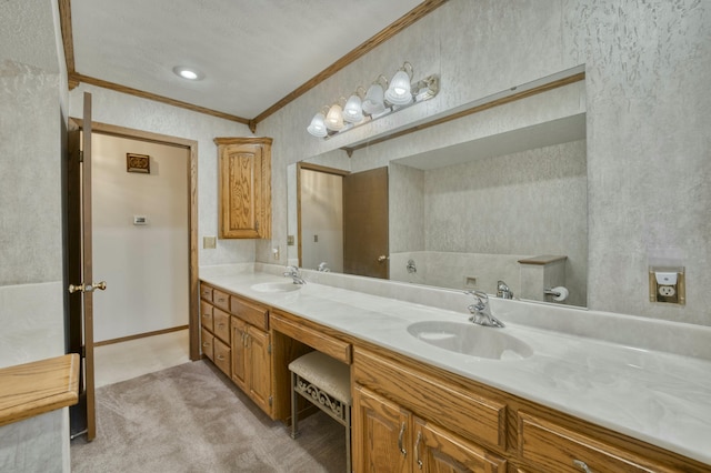 bathroom with vanity, ornamental molding, and a textured ceiling