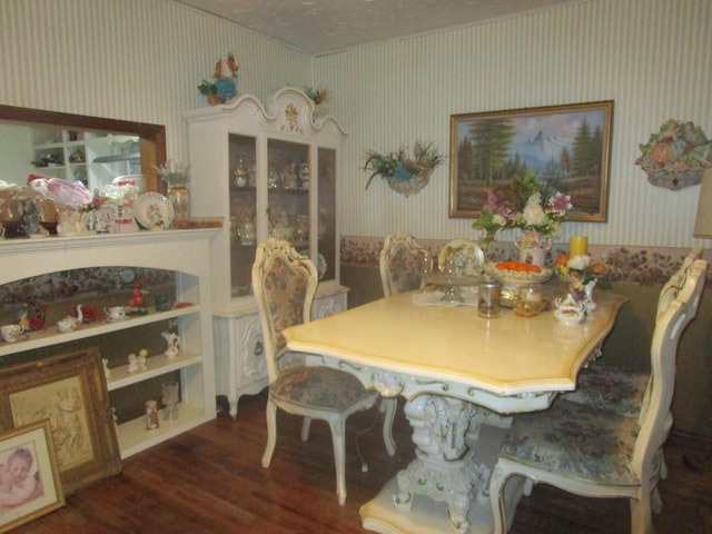 dining room with built in features and dark wood-type flooring