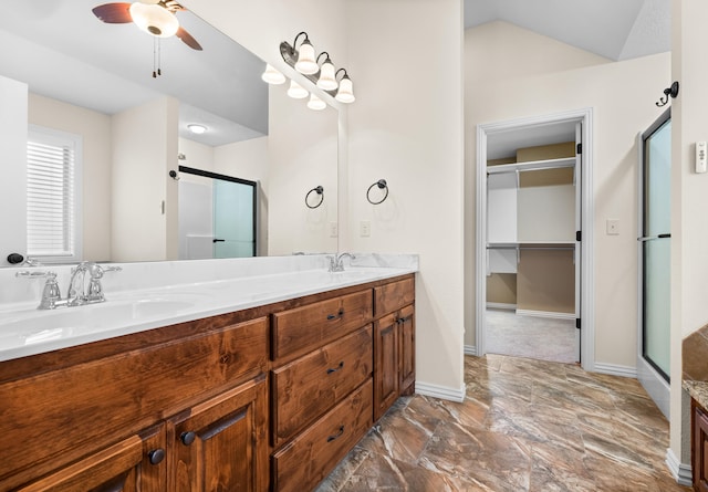 bathroom with vanity, ceiling fan, and walk in shower