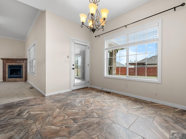 unfurnished dining area with crown molding and a chandelier