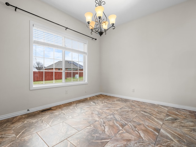 unfurnished room featuring an inviting chandelier