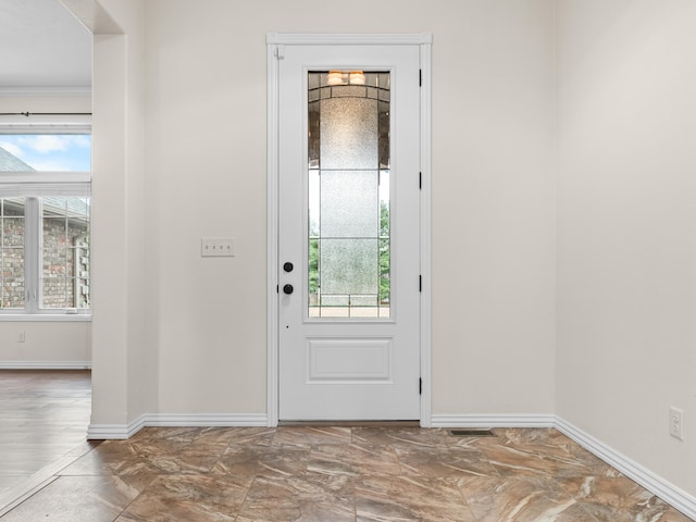 entrance foyer with plenty of natural light and crown molding