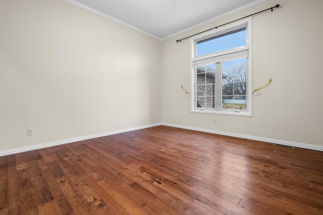 spare room with hardwood / wood-style floors and ornamental molding