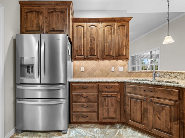 kitchen featuring sink, crown molding, stainless steel refrigerator with ice dispenser, tasteful backsplash, and light stone counters