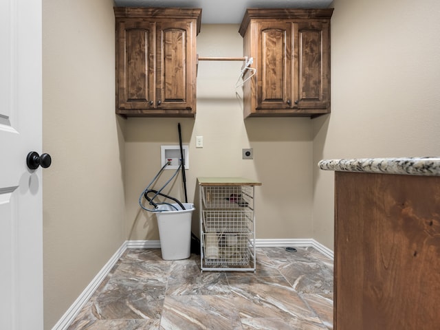 washroom with hookup for an electric dryer, cabinets, and washer hookup