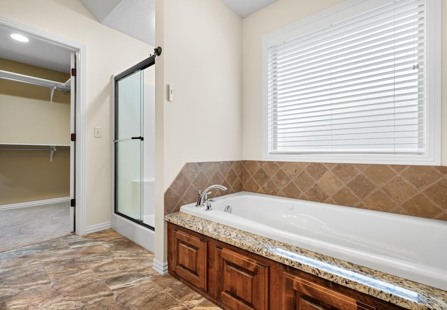 bathroom featuring separate shower and tub