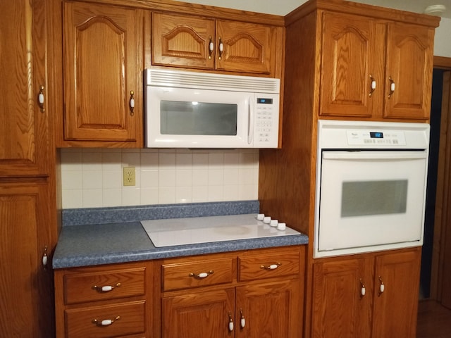 kitchen with white appliances and backsplash