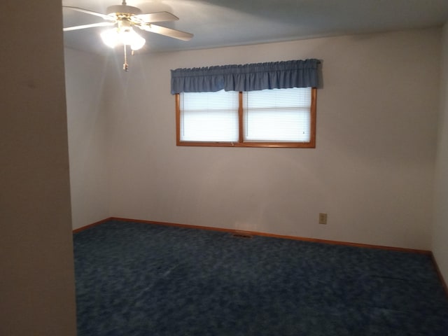 carpeted empty room featuring ceiling fan