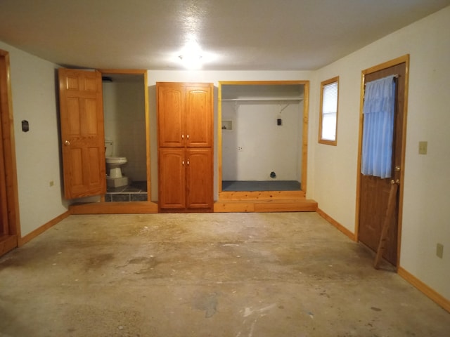 unfurnished bedroom featuring ensuite bathroom and a closet