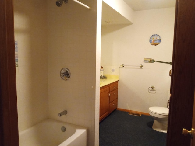 full bathroom with toilet, vanity, and tiled shower / bath combo