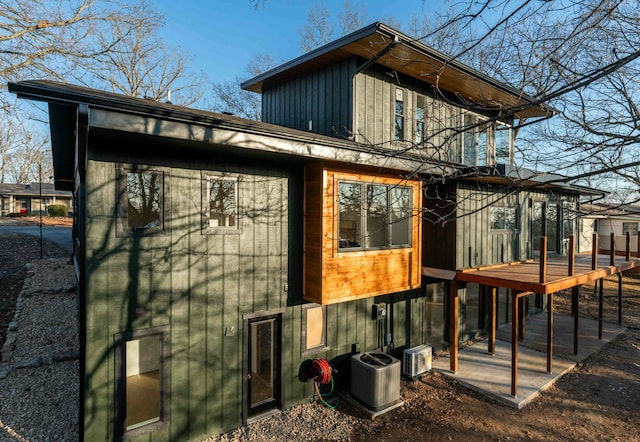 view of side of property with cooling unit and a deck