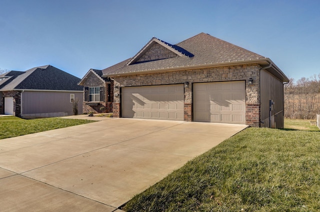 view of front of home featuring a front lawn and a garage