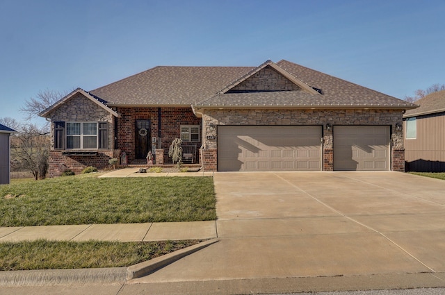 view of front of house with a front yard and a garage