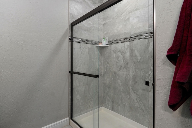 bathroom with a shower with shower door