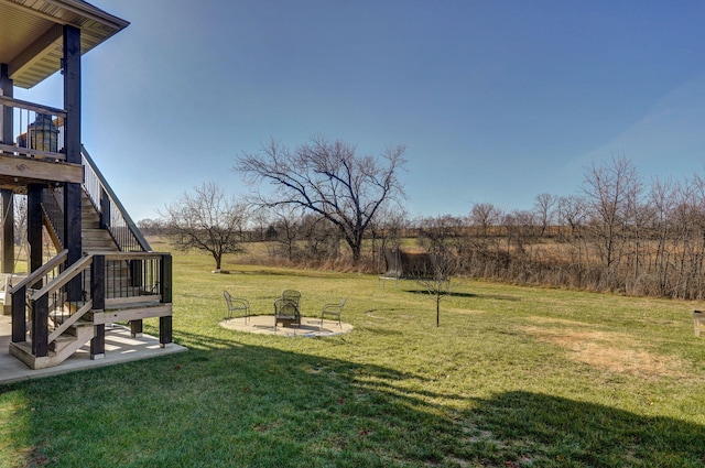 view of yard with a rural view and an outdoor fire pit