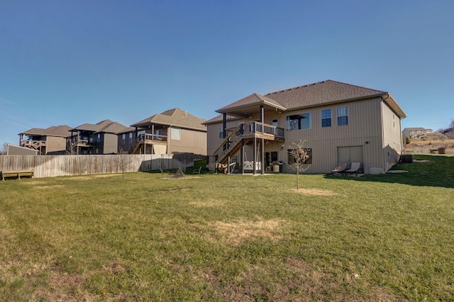 back of property featuring a lawn and a wooden deck