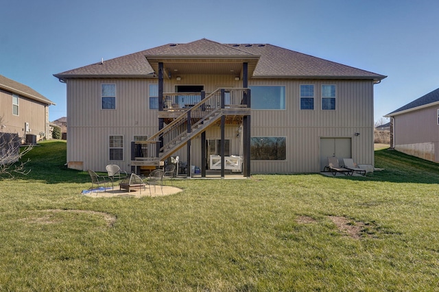 back of property featuring a yard, an outdoor fire pit, central air condition unit, a wooden deck, and a patio area