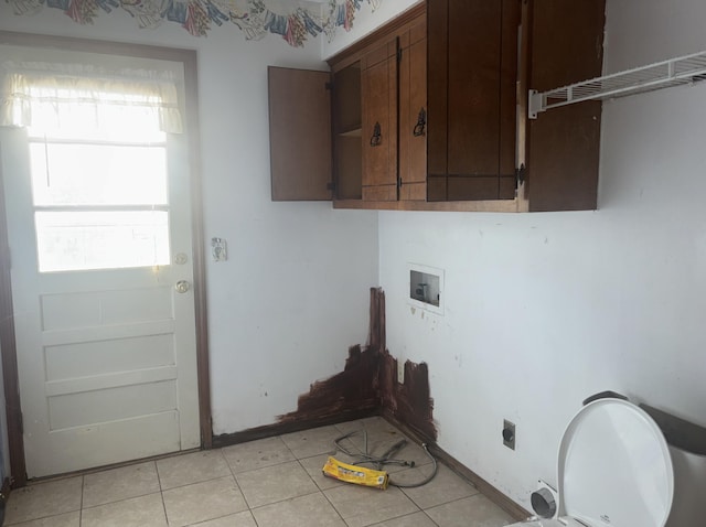 laundry room featuring cabinets, electric dryer hookup, washer hookup, and light tile patterned floors