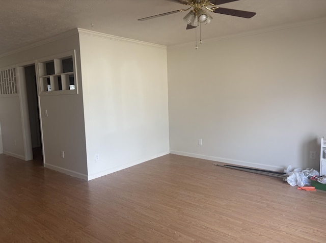 unfurnished room featuring hardwood / wood-style flooring, crown molding, and ceiling fan